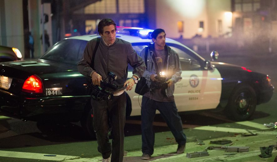 Jake Gyllenhaal, left, and Riz Ahmed appear in a scene from the film, &quot;Nightcrawler.&quot; This nervy and often gripping movie is about evil voyeurism and local news, which in &quot;Nightcrawler&#x27;s&quot; bleak satirical universe are the same thing. (Open Road Films via Associated Press)