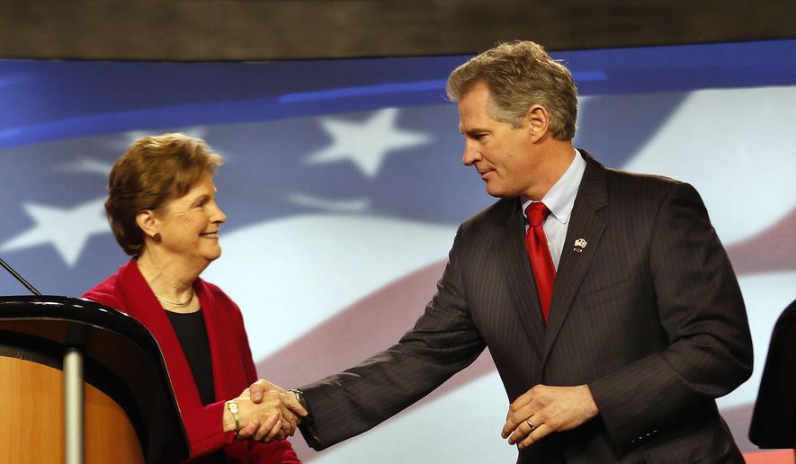 Democrat, U.S. Sen Jeanne Shaheen, left, shakes hands with her Republican opponent, former Massachusetts U.S. Sen. Scott Brown, before a live televised debate for U.S. Senate hosted by WMUR, the New Hampshire Union Leader, and The New Hampshire Institute of Politics at Saint Anselm College, Thursday, Oct. 30, 2014, in Manchester, N.H. (AP Photo/Jim Cole)