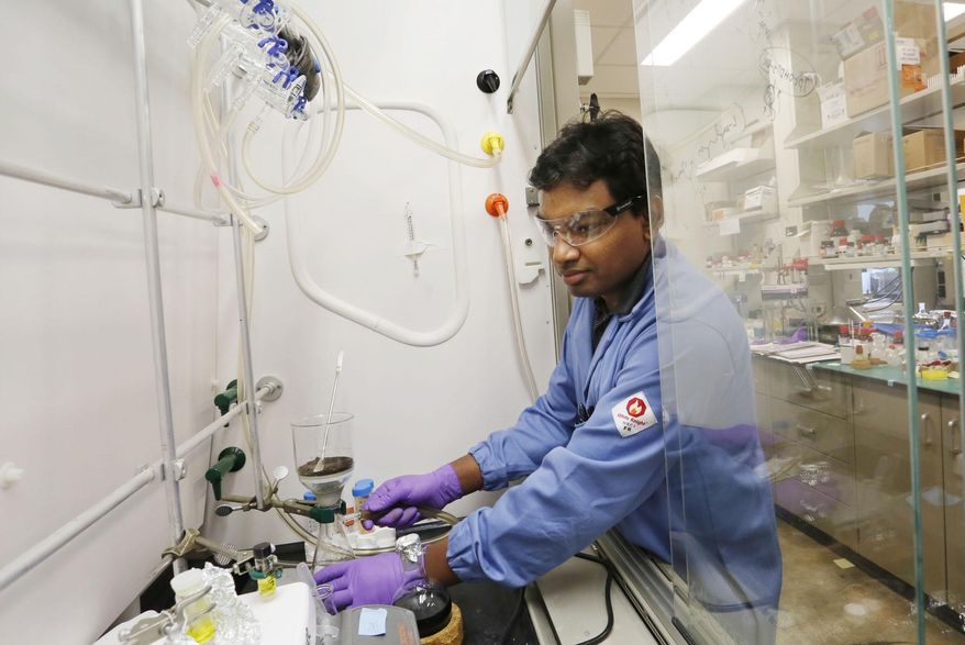 ADVANCE FOR THE WEEKEND OF NOV. 1-2 AND THEREAFTER - Sakkarapalayam Mahalingam prepares dye compounds to color cancer cells in a lab of professor Philip Low Tuesday, Oct.21, 2014, in the Drug Discovery Facility on the campus of Purdue University in West Lafayette, Ind. Once the cancer cells have been colored with the dye, they can be selectively targeted by anti-cancer drugs. It's high-profile faculty members such as Low who the university count on to keep a steady influx of research grants. (AP Photo/Journal & Courier, John Terhune)