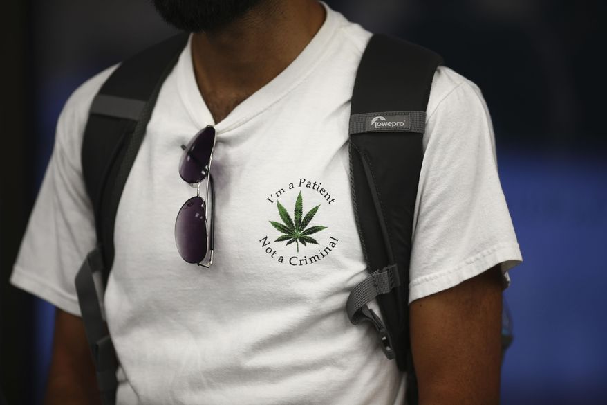 In this Oct. 8, 2014 photo, an individual displays their support for marijuana reform, during a debate in Boca Raton, Fla. The debate over legalizing medical marijuana in Florida constantly generates talk of young people potentially flooding the polls. But seniors are the most reliable voters and could be key to the measure’s success. Though polling on Amendment 2 has been erratic, seniors have been showing a level of interest in the initiative that underscores the fact they may benefit most from its passage. “You get older, you get sick, you start getting diseases, your bones stop working as well as they used to and you're presented with this pharmacopoeia of different drugs that you have to take just to get through the day,” said Ben Pollara, who leads United for Care, the pro-Amendment 2 campaign. (AP Photo/J Pat Carter)