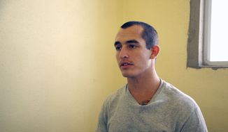 FILE - This May 3, 2014, file photo shows Sgt. Andrew Tahmooressi left, who is being held at Tijuana&#39;s La Mesa Penitentiary. A Mexican judge Friday Oct. 31, 2014 ordered the immediate release of a jailed U.S. Marine veteran who spent eight months behind bars for crossing the border with loaded guns. (AP Photo/UT San Diego, Alejandro Tamayo, File)