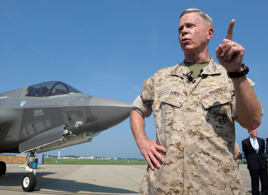 Former Marine Corps Commandant Gen. James Amos is getting support from Defense Secretary Hagel, who said the disputed official resume was not created by Gen. Amos but rather by a data center. (Associated Press)