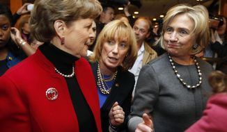 Hillary Rodham Clinton, right, greets voters with, U.S. Sen. Jeanne Shaheen, D-N.H., far left and Gov. Maggie Hassan, D-N.H., center at the puritan Backroom Restaurant, Sunday, Nov. 2, 2014 in Manchester, N.H. (AP Photo/Jim Cole)