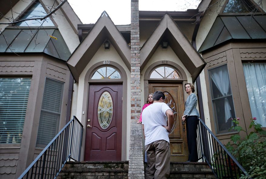In a final campaign push, Georgia U.S. Senate Democratic candidate Michelle Nunn rings a doorbell Monday while canvassing a neighborhood for voter support with daughter Elizabeth Martin and volunteer Connor Stubbs. (Associated Press)