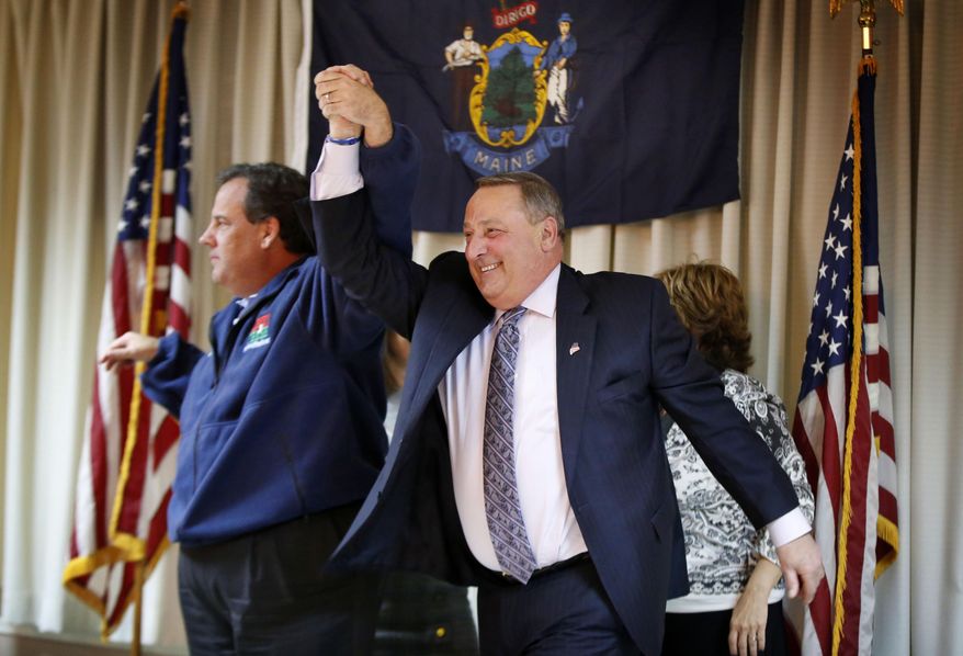 New Jersey Gov. Chris Christie, left, and Maine Gov. Paul LePage, acknowledge applause at a campaign rally for LePage, Monday, Nov. 3, 2014, in Portland, Maine. LePage is being challenged by Democrat Mike Michaud and independent Elliot Cutler. (AP Photo/Robert F. Bukaty)