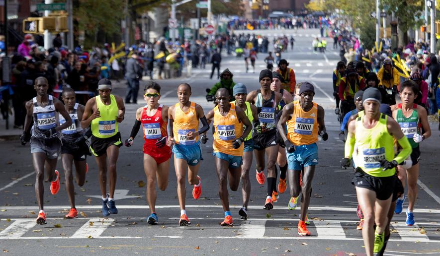 Runners in the men&#39;s division move through the borough of Brooklyn during the New York City Marathon in New York Sunday, Nov. 2, 2014. (AP Photo/Craig Ruttle)