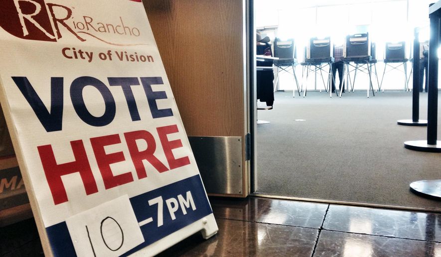 In a Saturday, Nov.1, 2014 photo a sign directs voters to a satellite location where they could cast ballots on the last day of early voting in Rio Rancho, N.M. Candidates followed up with final campaign stops and last-minute appeals to voters Monday, Nov. 3, 2014, in races from the U.S. Senate and governorship to legislative contests that could shift the balance of power for the first time in more than a half century. (AP Photo/Susan Montoya Bryan)