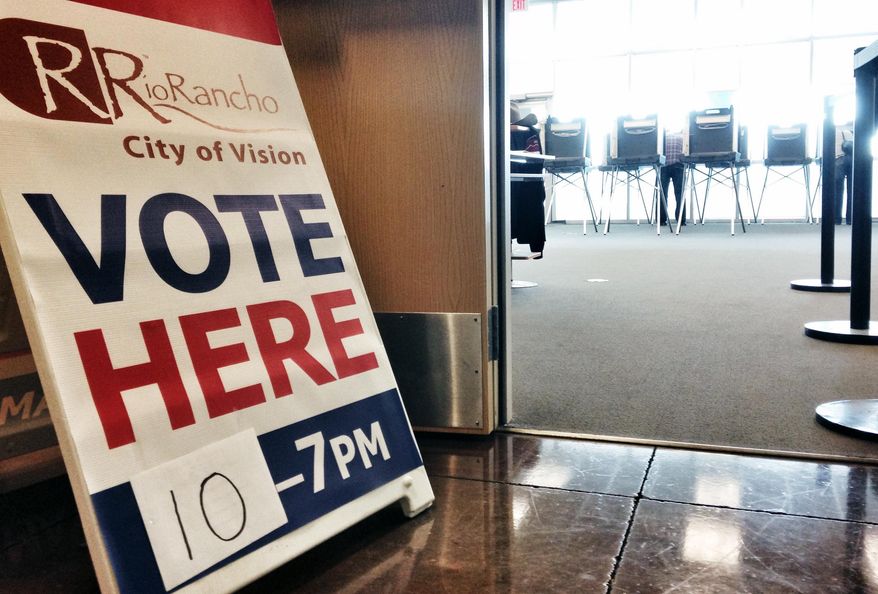 In a Saturday, Nov.1, 2014 photo a sign directs voters to a satellite location where they could cast ballots on the last day of early voting in Rio Rancho, N.M. Candidates followed up with final campaign stops and last-minute appeals to voters Monday, Nov. 3, 2014, in races from the U.S. Senate and governorship to legislative contests that could shift the balance of power for the first time in more than a half century. (AP Photo/Susan Montoya Bryan)