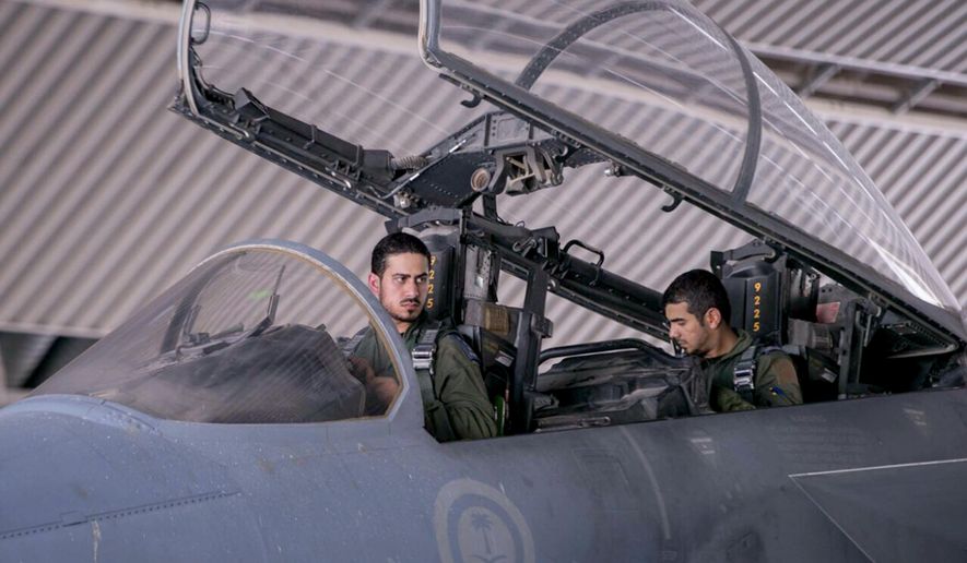In this file photo released Wednesday, Sept. 24, 2014, by the official Saudi Press Agency, Saudi pilots sits in the cockpit of a fighter jet as part of U.S.-led coalition airstrikes on Islamic State militants and other targets in Syria. (AP Photo/Saudi Press Agency, File)