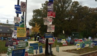 Campaign signs representing races across the city were posted outside an early voting site at the Takoma Community and Aquatic Center in Northwest D.C. on Saturday, the last day of voting ahead of Tuesday&#39;s elections. (Andrea Noble/The Washington Times)