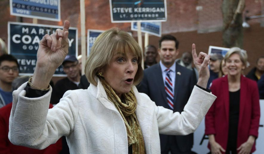 Massachusetts Democratic gubernatorial candidate Martha Coakley, left, raises her arms while speaking to a crowd as U.S. Sen Elizabeth Warren, D-Mass., right, and Democrat Seth Moulton, a candidate for the U.S. House of Representatives, second from right, look on during a campaign event, Monday, Nov. 3, 2014, in Lynn, Mass. (AP Photo/Steven Senne)
