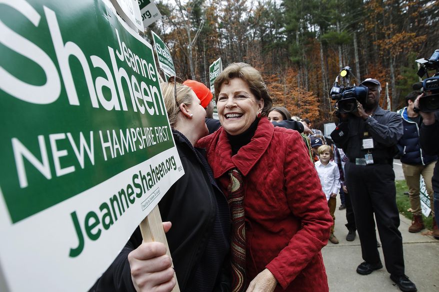Sen. Jeanne Shaheen, D-N.H., hugs a volunteer holding a sign as she heads in to vote at the Town Hall in Madbury, NH, Tuesday, Nov. 4, 2014. Shaheen, a Democrat seeking a second term, faces Republican Scott Brown, who is seeking to represent a second state. Brown moved to New Hampshire last year after losing his U.S. Senate seat in Massachusetts. (AP Photo/Cheryl Senter)