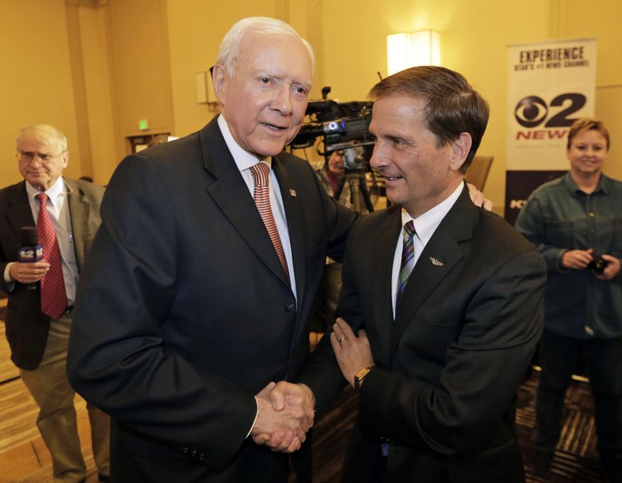 Sen. Orrin Hatch, R-Utah, left, shakes hands with Republican congressional candidate Chris Stewart during the Utah State GOP election night watch party, Tuesday, Nov. 4, 2014, in Salt Lake City. Stewart is seeking a second term in the 2nd Congressional District. (AP Photo/Rick Bowmer)