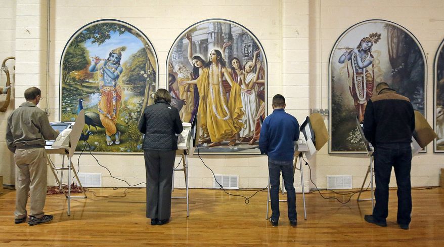 People vote at the polling place in Krishna Temple during election day Tuesday, Nov. 4, 2014, in Salt Lake City. Utah's most watched race this year is the contest to replace longtime Democratic Rep. Jim Matheson in Utah's 4th Congressional District. (AP Photo/Rick Bowmer)