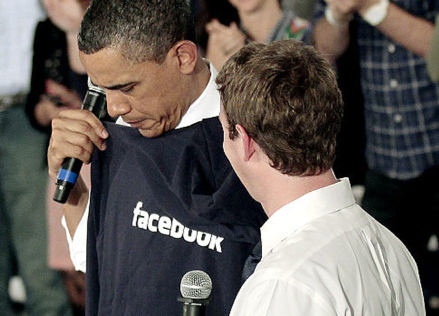 President Obama is given a Facebook sweatshirt by founder Mark Zuckerberg at an event in Silicon Valley, Calif., April 21, 2011. (Associated Press)