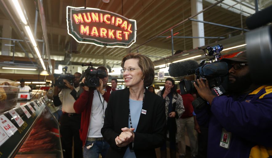 Georgia Democratic Senate candidate Michelle Nunn walks in the Atlanta municipal market, Tuesday, Nov. 4, 2014, in Atlanta. Nunn is facing Republican businessman David Perdue in the Georgia Senate race. (AP Photo/John Bazemore)