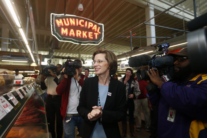 Georgia Democratic Senate candidate Michelle Nunn walks in the Atlanta municipal market, Tuesday, Nov. 4, 2014, in Atlanta. Nunn is facing Republican businessman David Perdue in the Georgia Senate race. (AP Photo/John Bazemore)