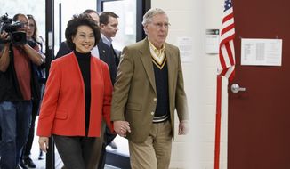 Senate Minority Leader Mitch McConnell of Ky., and his wife, former Labor Secretary Elaine Chao, arrive to cast their ballots in the midterm election at their voting precinct at Bellarmine University in Louisville, Ky., Tuesday, Nov. 4, 2014.  The Kentucky Senate race, with McConnell, a 30-year incumbent, facing a spirited challenge from Democrat Alison Lundergan Grimes, has been among the most combative and closely watched contests that could shift the balance of power in Congress. (AP Photo/J. Scott Applewhite)