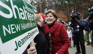 Sen. Jeanne Shaheen, D-N.H., hugs a volunteer holding a sign as she heads in to vote at the Town Hall in Madbury, NH,  Tuesday, Nov. 4, 2014.  Shaheen, a Democrat seeking a second term, faces Republican Scott Brown, who is seeking to represent a second state. Brown moved to New Hampshire last year after losing his U.S. Senate seat in Massachusetts.  (AP Photo/Cheryl Senter) 