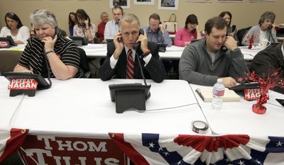 The campaign between Republican Senate candidate Thom Tillis (center) and incumbent Sen. Kay R. Hagan has cost $111 million. (AP Photo/Chuck Burton)
