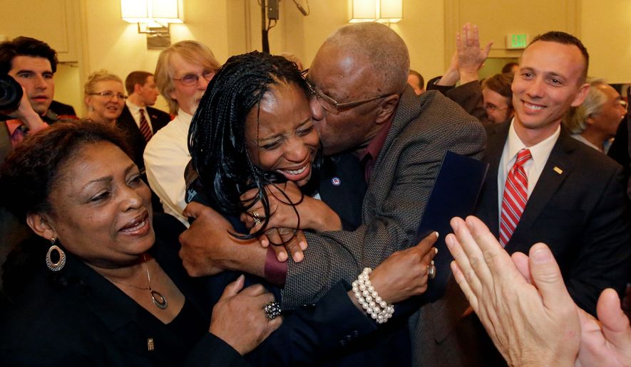 Republican Mia Love celebrates with her father, Jean Maxime Bourdeau, after winning the race for Utah&#39;s 4th Congressional District during the Utah State GOP election night watch party, Tuesday, Nov. 4, 2014, in Salt Lake City. Love becomes first black female Republican elected to Congress. (AP Photo/Rick Bowmer)