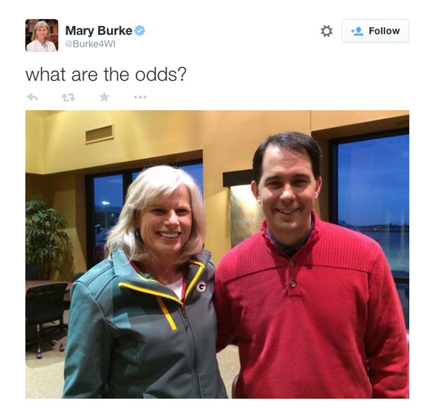 In this frame grab provided by Mary Burke's campaign Republican Wisconsin Gov. Scott Walker and Democratic challenger Mary Burke pose for a photo tweeted Tuesday, Nov. 3, 2014 by Burke's campaign after the two ran into each other at the airport in Green Bay, Wis. The two are locked in a close race for governor and have been rushing around the state in last-minute, get-out-the vote efforts. (AP Photo/Mary Burke campaign)