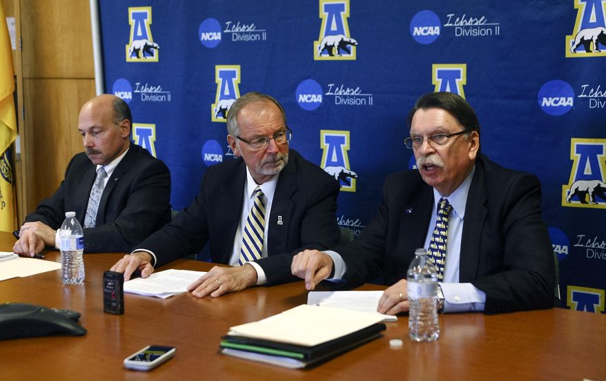 Chancellor Brian Rogers, right, speaks during a news conference with Athletic Director Gary Gray, center, and Vice Chancellor for University and Student Advancement Michael Sfraga, in the University of Alaska Fairbanks Alumni Lounge, Wednesday, Nov. 5, 2014, in Fairbanks, Alaska. The University of Alaska Fairbanks has been fined $30,000 and will not be eligible for postseason play in several sports because of NCAA infractions handed down Wednesday. (AP Photo/Fairbanks Daily News-Miner, Erin Corneliussen)