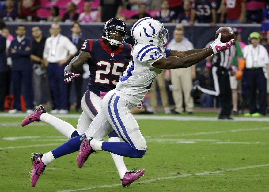 FILE - In this Oct. 9, 2014, file photo, Indianapolis Colts' T.Y. Hilton (13) catches a pass in front of Houston Texans' Kareem Jackson (25) during the first quarter of an NFL football game in Houston. Hilton broke out last year with 82 receptions for 1,083 yards, taking over as Andrew Luck's favorite target after Reggie Wayne went down with an injury. Still, he wasn't generally mentioned before this season as being in the upper echelon of the league's wide receivers with guys such as Calvin Johnson, Julio Jones and Dez Bryant.(AP Photo/David J. Phillip, File)