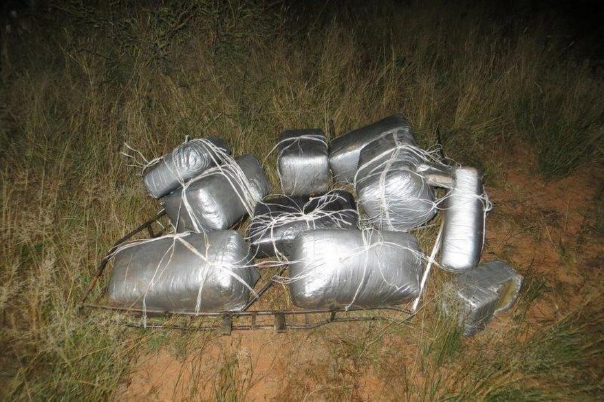 This undated photo provided by the U.S. Customs and Border Protection shows nearly 185 pounds of marijuana that was recovered after an ultralight aircraft was seen flying from Mexico into southeastern Arizona. Two people were arrested Wednesday, Nov. 5, 2014 near where the marijuana was found in the vicinity of Sunsites, a small community located about 40 miles north of the U.S.-Mexico border. According to the Border Patrol, camera operators from the agency's Douglas station observed the ultralight fly north over the border at approximately 3 a.m. It then was seen traveling south back into Mexico at approximately 4:45 a.m. (AP Photo/U.S. Customs and Border Protection)