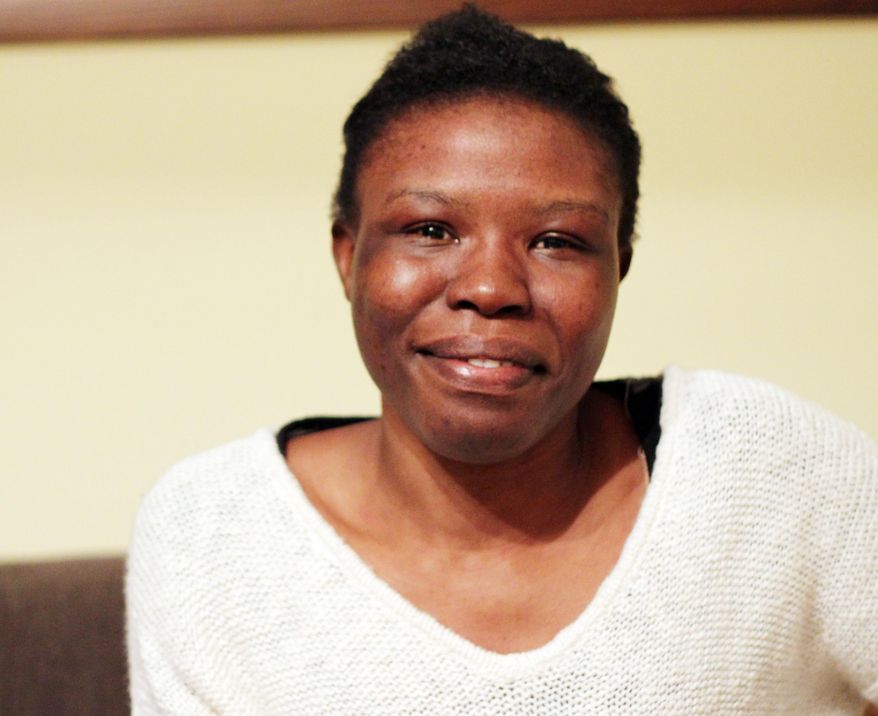 ADVANCE FOR WEEKEND EDITIONS NOV. 8-9 - In this Nov. 3, 2014 photo, Martine Tchitchihe poses for a photo in Fergus Falls, Minn. Martine Tchitchihe chose school over marriage. For that, she says she was beaten and threatened by the African terror group Boko Haram. The Cameroon native came to the United States a month ago as part of a short teaching-exchange stint in Fergus Falls, Minnesota. She's seeking asylum here now and plans to help run a scholarship program for girls in her home country. (AP Photo/Minnesota Public Radio, Laura Yuen)