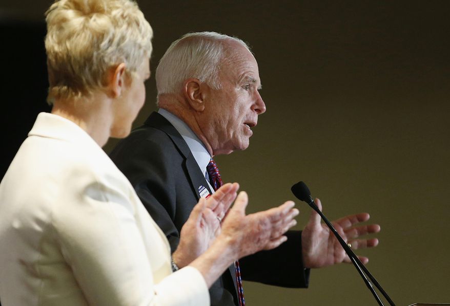 Arizona Republican Sen. John McCain, right, speaks to the crowd as wife Cindy McCain applauds her husband at election night festivities Tuesday, Nov. 4, 2014, in Phoenix. (AP Photos/Ross D. Franklin)