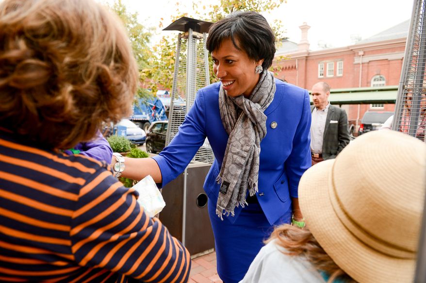Democratic candidate for Mayor Muriel Bowser greets people on the street at Eastern Market on election day, Washington, D.C., Tuesday, November 4, 2014. (Andrew Harnik/The Washington Times)