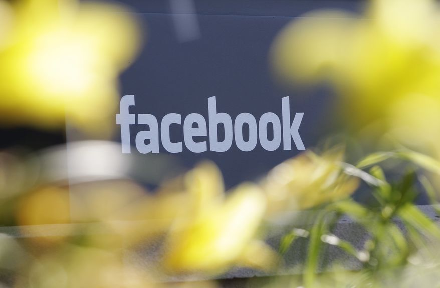 FILE - This Friday, May 18, 2012, file photo shows Facebook&#39;s headquarters behind flowers in Menlo Park, Calif. Facebook is stepping up its efforts to fight Ebola by adding a button designed to make it easier for its users to donate to charities battling the disease. (AP Photo/Paul Sakuma, File)