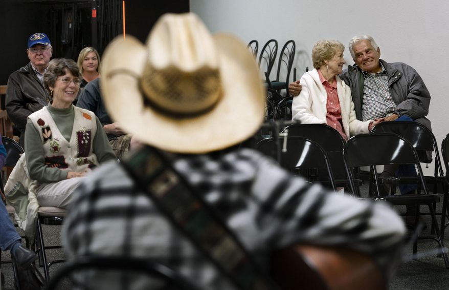 Dolly Heil and Dick Sharpe, right, listen to the music during a weekly jam session at Silver Lake Mall in Coeur d'Alene, Idaho on Friday, Oct. 24, 2014. Area malls have reinvented themselves and survived the recession. (AP Photo/The Spokesman-Review, Kathy Plonka)