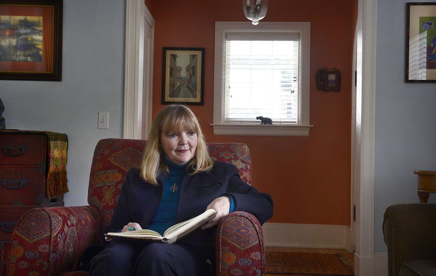 Rev. Patty Willis, pastor at South Valley Unitarian Universalist Church reads in her living room in Salt Lake City home, Thursday, Nov. 6, 2014. (AP Photo/The Salt Lake Tribune, Scott Sommerdorf)