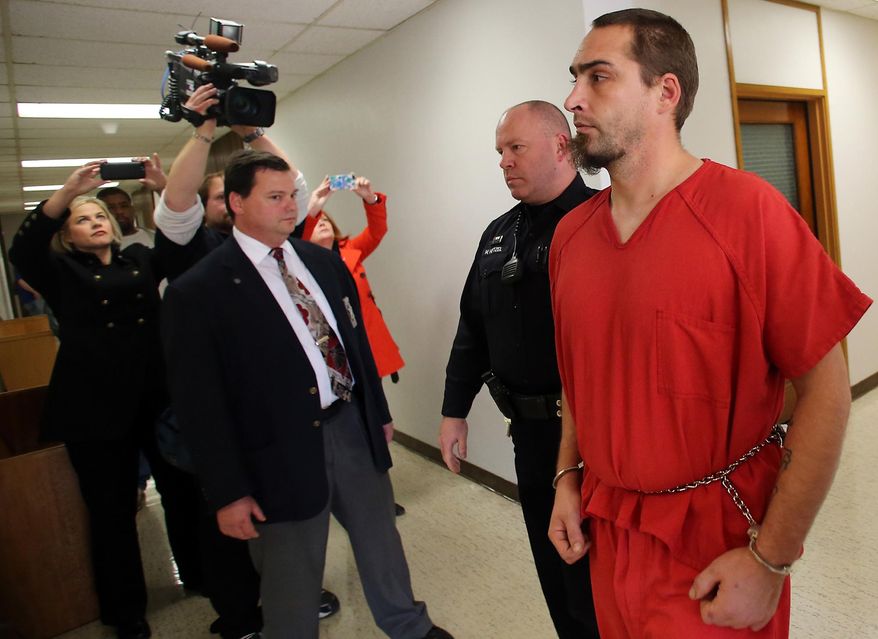 David Michael Kalac, accused of killing his girlfriend Amber Lynn Coplin, 30, and posting grisly photos of her body online, is lead into a courtroom for an arraignment hearing at Kitsap County Superior Court, Friday, Nov. 7, 2014, in Port Orchard, Wash. Kalac was charged with first-degree murder with a special allegation of domestic violence and an aggravated circumstance of having an impact on people other than the victim. Bail was set at $2 million.(AP Photo/Kitsap Sun, Meegan M. Reid)