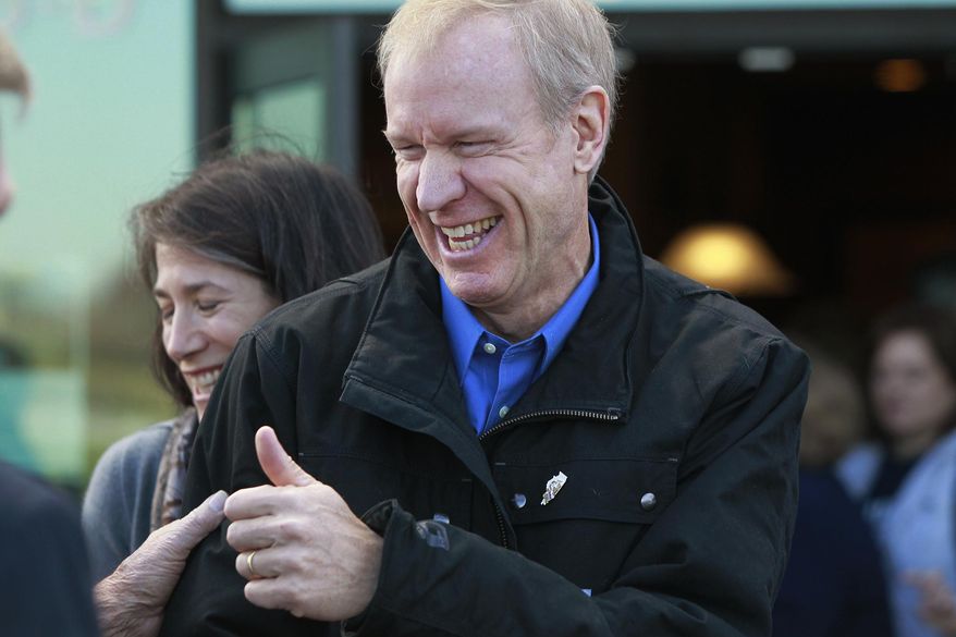 Illinois Gov.-elect Bruce Rauner gives a thumbs up as he visits with patrons at a restaurant in O’Fallon, Ill., Friday, Nov. 7, 2014, to thank supporters following his election win over incumbent Gov. Pat Quinn. (AP Photo/Belleville News-Democrat, Derik Holtmann)