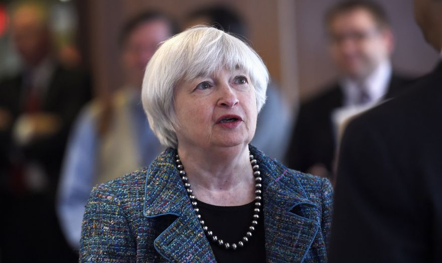 FILE - In this Oct. 30, 2014 file photo, Federal Reserve Chair Janet Yellen talks with guests before speaking at The National Summit on Diversity in the Economics Profession hosted by the Federal Reserve System, at the Federal Reserve in Washington. Yellen says the Fed is striving to clearly communicate its intentions on interest rates in order to minimize surprises that could disrupt financial markets both in the United States and globally. Yellen's comments came in a speech Friday, Nov. 7, 2014, in Paris at a conference sponsored by the Bank of France. (AP Photo/Susan Walsh) **FILE**