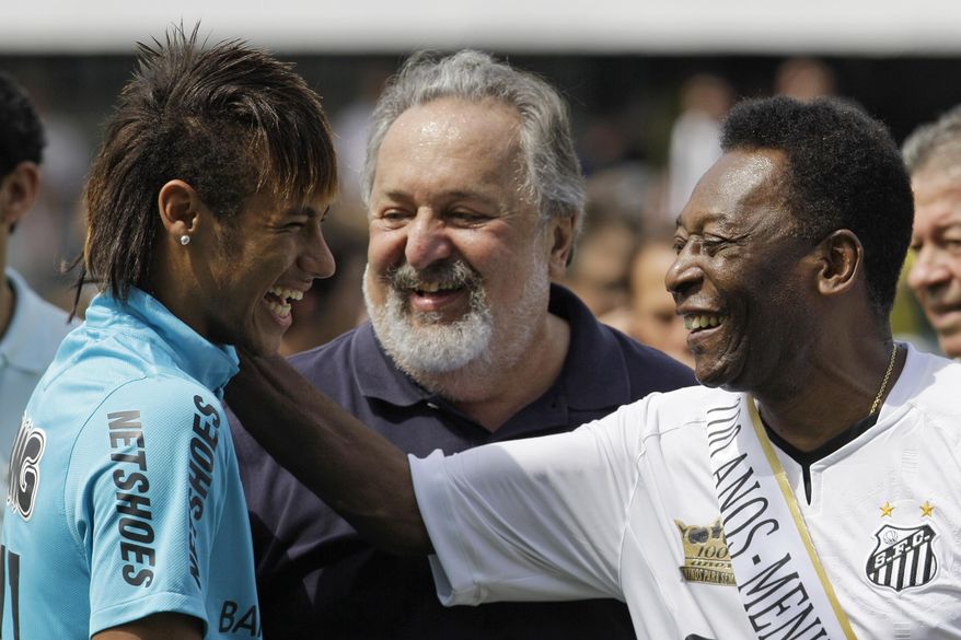 FILE - In this April 14, 2012 file photo, soccer player Neymar, left, and former soccer player Pele, right,  shares a laugh during the centennial anniversary celebration of the team in Santos, Brazil. Brazil’s most promising player in decades is living up to expectations, enchanting with his skills and putting up numbers that set him on a path to greatness. He is already Brazil’s fifth-greatest goal scorer, and is well on pace to surpass Pele’s record as the nation’s most prolific scorer. If Neymar keeps scoring like this, he may break Pele’s record before he turns 28 in 2020. Pele was only two months older than Neymar when he netted his 40th goal. Only Pele and Romario have a better goal average than Neymar with the national team. (AP Photo/Nelson Antoine, File)