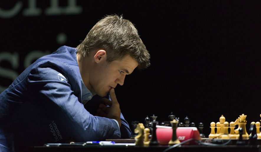 Norway's Magnus Carlsen, currently the top ranked chess player in the world, thinks over his move as he plays against India's former World Champion Vishwanathan Anand at the FIDE World Chess Championship Match in Sochi, Russia, Saturday, Nov. 8, 2014. (AP Photo/Artur Lebedev)