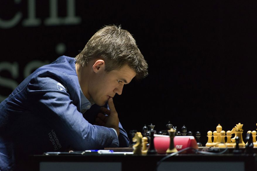 Norway's Magnus Carlsen, currently the top ranked chess player in the world, thinks over his move as he plays against India's former World Champion Vishwanathan Anand at the FIDE World Chess Championship Match in Sochi, Russia, Saturday, Nov. 8, 2014. (AP Photo/Artur Lebedev)