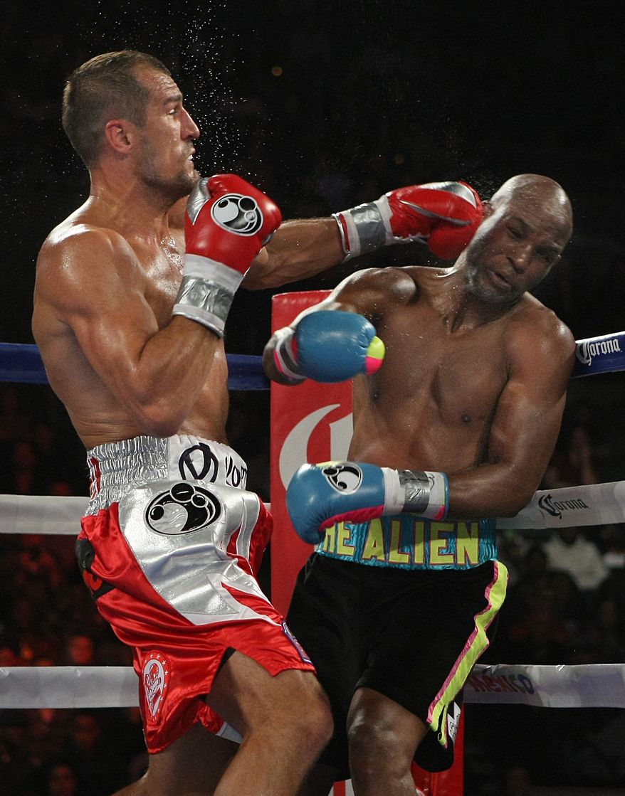 Bernard Hopkins of Philadelphia, PA, right, gets hit by Sergey Kovalev of Russia during the third round of the Main Event IBF, WBA and WBO Light Heavyweight Titles boxing in Atlantic City, N.J. on Saturday, Nov. 8, 2014. Kovalev won by TKO in the 12th round. (AP Photo/Tim Larsen)