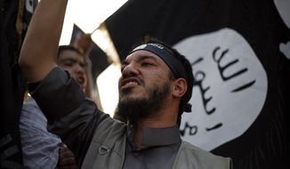 A Libyan follower of Ansar al-Shariah Brigades chants anti-U.S. slogans during a protest in front of the Tibesti Hotel, in Benghazi, Libya, on Sept. 14, 2012 (Associated Press) ** FILE **