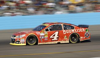 Kevin Harvick drives out of turn four during the Quicken Loans Race for Heroes 500 NASCAR Sprint Cup Series auto race at Phoenix International Raceway, Sunday, Nov. 9, 2014, in Avondale, Ariz. (AP Photo/Ralph Freso) 