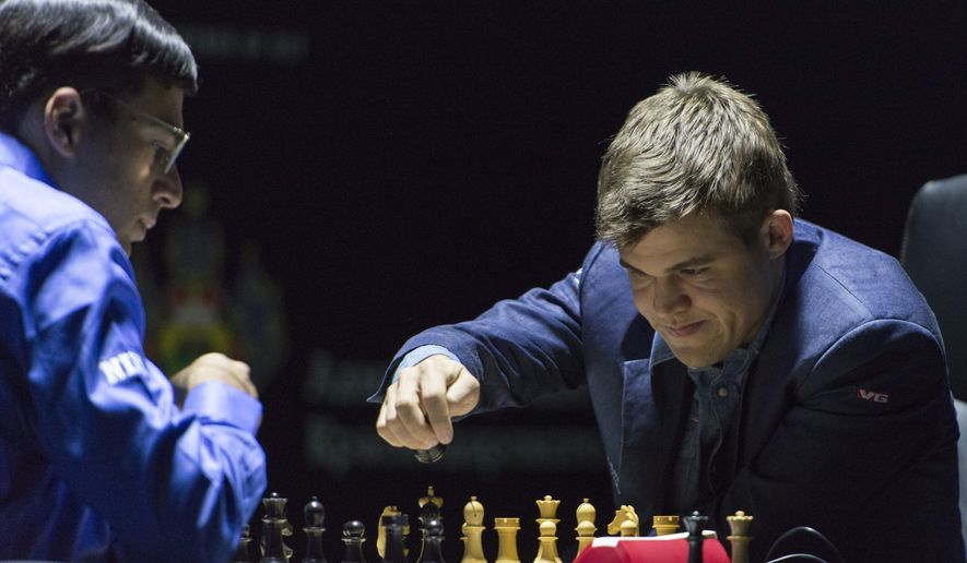 Norway&#39;s Magnus Carlsen, currently the top ranked chess player in the world, right,  makes a move as he plays against India&#39;s former World Champion Vishwanathan Anand at the FIDE World Chess Championship Match in Sochi, Russia, Sunday, Nov. 9, 2014. (AP Photo/Artur Lebedev)