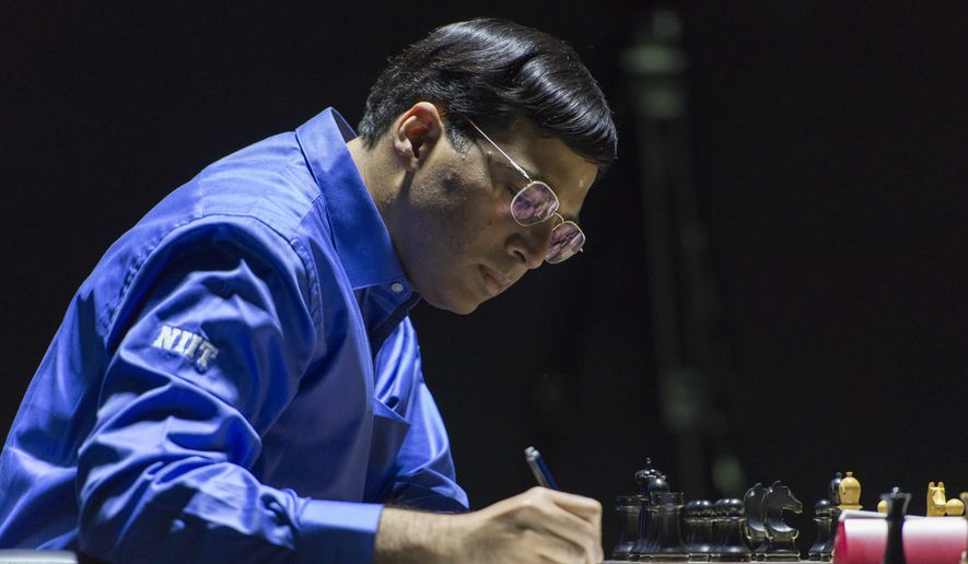 India&#39;s former World Champion Vishwanathan Anand makes notes as he plays against Norway&#39;s Magnus Carlsen, currently the top ranked chess player in the world, at the FIDE World Chess Championship Match in Sochi, Russia, Sunday, Nov. 9, 2014. (AP Photo/Artur Lebedev)