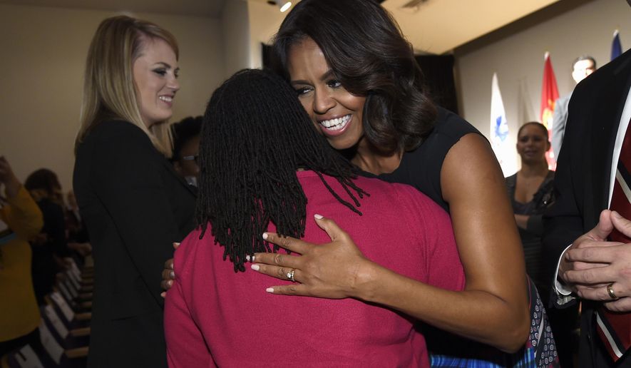 First lady Michelle Obama greets people after speaking at the Women Veterans Career Development Forum at the Women in Military Service for America Memorial (WIMSA) at Arlington National Cemetery in Arlington, Va., Monday, Nov. 10, 2014. (AP Photo/Susan Walsh)