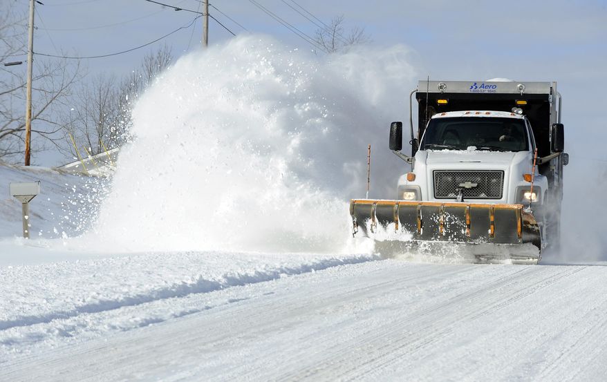 FILE - In this March 3, 2013 file photo a state road plow kicks up a cloud of snow while clearing U.S. Highway 62 in Baxter County, Ark. The Arkansas State Highway and Transportation Department will hold a job fair on Nov. 14, citing the need to hire truck drivers, with winter approaching. (AP Photo/The Baxter Bulletin, Kevin Pieper, File)