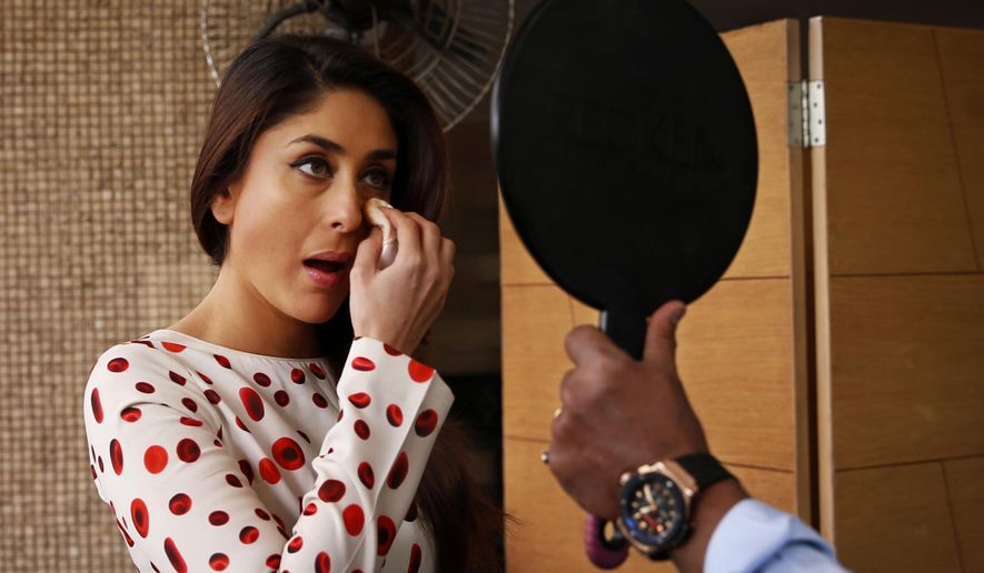 FILE - In this Monday, Aug. 11, 2014 file photo, Indian actress Kareena Kapoor retouches her makes up before a photocall to promote her film "Singham Returns" in New Delhi, India. The Supreme Court has ordered the lifting of a nearly 6-decade de facto ban on women working as makeup artists in India's movie industry. (AP Photo/Saurabh Das, File)
