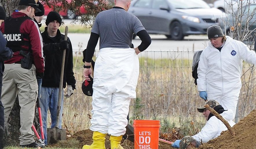 Members of law enforcement including Detroit police, dig, sift and using sub-surface imaging at the United Memorial Gardens cemetery, in Plymouth Township, Mich., Monday, Nov. 10, 2014. Authorities hoping to help close two cases from the 1980s are working to exhume two unidentified bodies at the cemetery. (AP Photo/Detroit News, Daniel Mears)